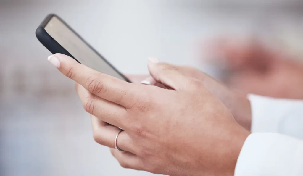 close up of hands using modern smartphone utc